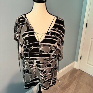 Black and cream lined short sleeve blouse with metal decoration at the neck